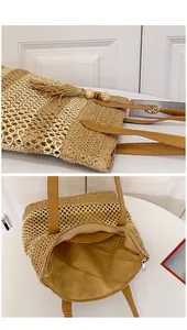 Detail view of woven straw tote bag featuring tassel accents and secure zipper closure