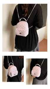 Detailed views of pink quilted mini backpack with silver studs and chain straps