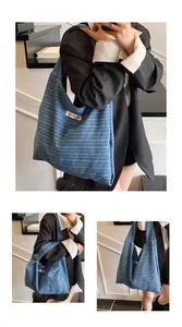 Close-up of blue striped canvas tote bag featuring a pink woven label detail