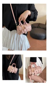 Detailed macro view of pink Boston bag with cartoon bear print and gold-tone hardware