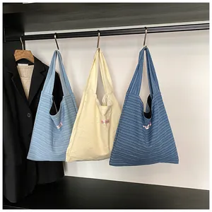 Close-up of knit tote bags with star jacquard patterns and textured striped fabric
