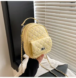 Detailed macro view of yellow quilted PU leather bag with sparkling rhinestones and chain