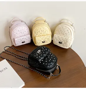 Detailed view of quilted mini backpacks in four colors with chain straps and metal studs