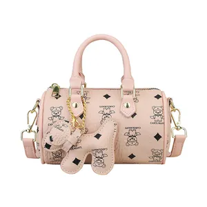 Pink Boston handbag with bear prints, dual handles, and adjustable shoulder strap