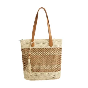 Hollow straw tote bag with leather straps and tassel detail for summer beach