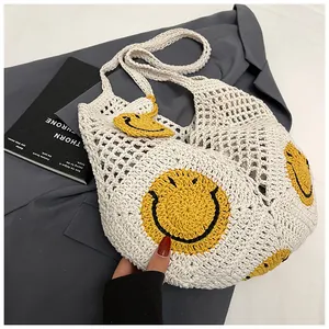 Close-up of white crochet tote bag featuring yellow smiley faces and woven texture details