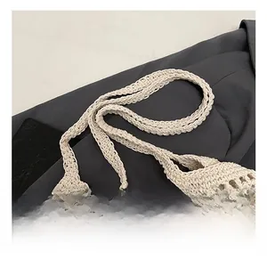 Detail shot of the reinforced hand-woven wide strap on a straw beach tote bag