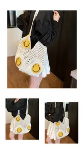 Detailed close-up of handmade white crochet tote bag with yellow smiley face patterns