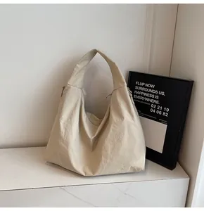 Detailed close-up of the beige large capacity tote bag with textured fabric and zipper