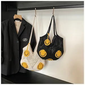 Detail showing hand-crocheted hollow mesh texture with vibrant yellow smiley face patches