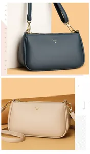 Detailed view of the deer logo and pebble leather texture on navy and beige crossbody bags