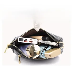 Internal view of large capacity crossbody bag showing phone, umbrella, and essentials