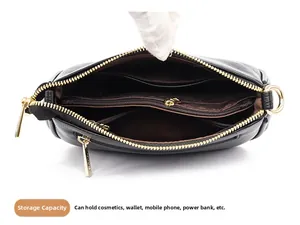 Detail view of large capacity crossbody bag with multiple interior compartments and gold zipper