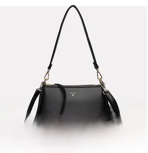 Close-up of black litchi grain leather bag with gold stag emblem and metallic hardware