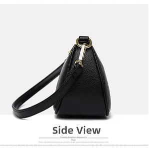 Side view of black pebble leather crossbody bag with gold hardware and triangular shape