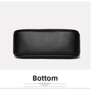 Detail view showing the reinforced bottom and neat stitching of the black pebbled leather bag