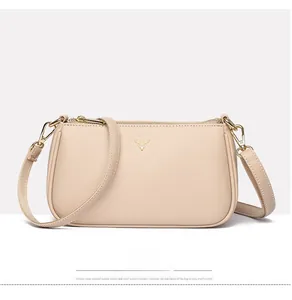 Close-up of beige lychee texture leather bag with golden deer logo and hardware details