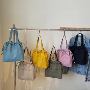 Large nylon tote bags in diverse colors with drawstring closure and shoulder straps