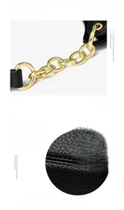 Detail einer Tasche aus schwarzem Lychee-Leder mit goldener Kette und feiner Naht