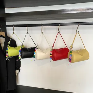 Minimalist pillow shoulder bag in five colors with bohemian bead charms and leather texture