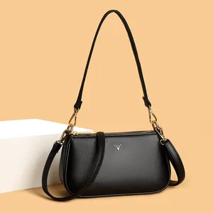Minimalist black lychee texture crossbody bag with silver deer logo and gold hardware