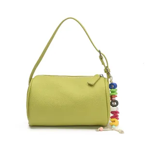 Minimalist avocado green cylinder shoulder bag with lychee texture and beaded charm