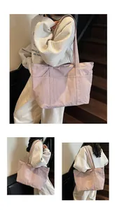 Detail of light purple nylon tote bag with pleated texture and functional front pocket