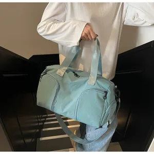 Detailed view of the water-resistant nylon fabric and side pockets on a light blue travel bag