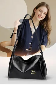 Detail of black leather Boston bag featuring a gold kangaroo logo and polished finish