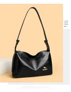Close-up of black textured leather Boston bag featuring a gold kangaroo logo and zipper