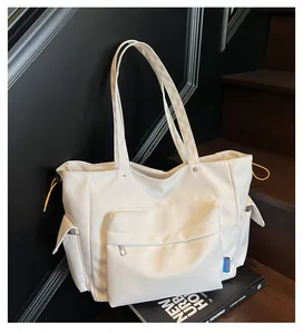 Close-up of white multi-pocket functional tote bag with yellow drawstring accents