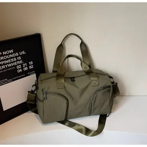 Detail of army green nylon sports bag showing spacious compartments and adjustable strap
