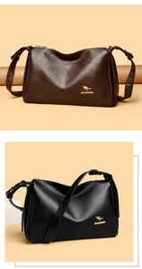 Macro view of grain leather texture with golden kangaroo logo on Boston crossbody bag