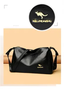 Detailed view of black Boston bag featuring golden kangaroo logo and textured leather finish