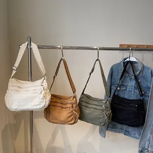 Casual canvas shoulder bags in four colors with multiple zipper pockets and wide straps