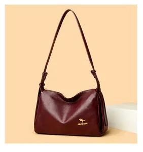 Detailed macro view of the wine red Boston bag texture and golden kangaroo logo