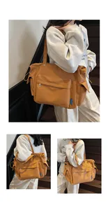 Detail view of large tan tote bag featuring drawstring side pockets and zippered front compartment