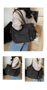 Detail view of black tote bag with multiple zipper pockets and yellow drawstrings