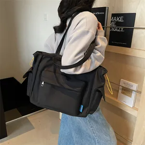 Minimalist black canvas tote bag for women with large capacity and multi-pocket design
