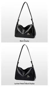 Detail shot of the black Boston bag showing smooth leather and lychee texture with gold logo