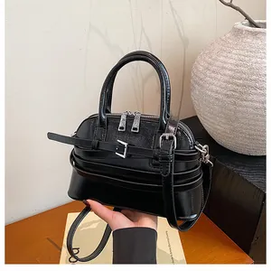 Detail of glossy black PU leather bowling bag featuring silver hardware and buckle