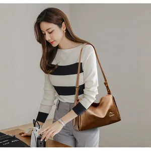 Classic brown leather Boston bag for women with kangaroo logo and adjustable strap