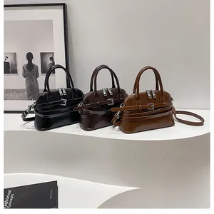 Detailed view of women's leather crossbody bags in black, dark coffee and caramel brown