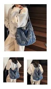 Detail view of large denim tote bag showing shoulder and crossbody styling options