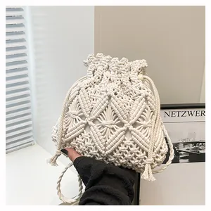 Detail of hand-woven off-white bucket bag featuring intricate grid knot design and drawstring