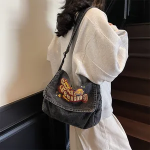 Washed grey denim tote bag with vintage embroidery and adjustable strap for daily use