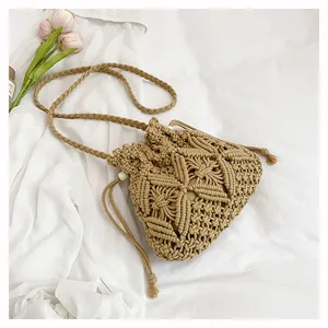 Close-up of woven macrame bucket bag with geometric hollow patterns and drawstring closure