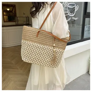 Detail of vintage patchwork woven tote with wood bead tassel and leather straps