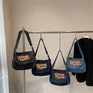 Retro denim messenger bags in four washes featuring embroidery for a casual streetwear look