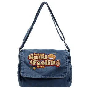 Large blue denim tote bag with colorful embroidery and adjustable strap for daily use